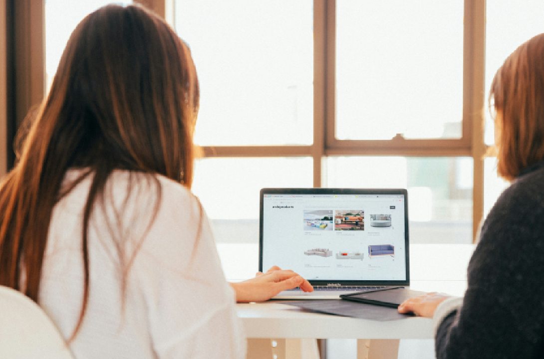 Women optimizing e-commerce landing page